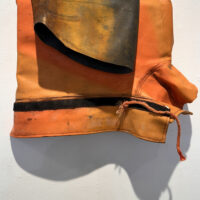 2024 rain jacket, inner tube, on wood 11 x 15 x 4 inches