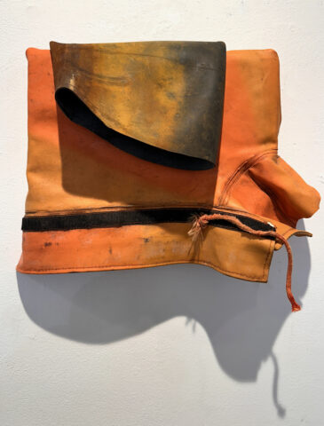 2024 rain jacket, inner tube, on wood 11 x 15 x 4 inches