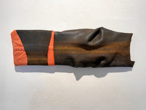 2016. fabric, inner tube on wood 8 x 22 x 2 1/2 inches
