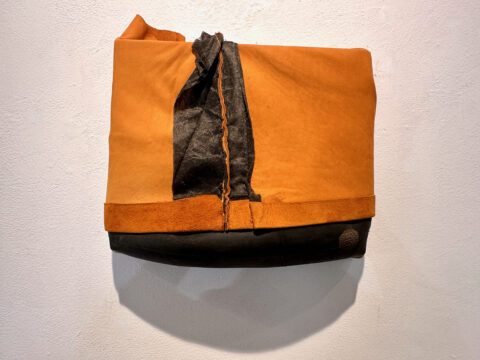 2024. suede jacket inner tube on wood 11 x 13 1/2 x 3 inches